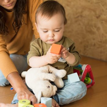 Mother playing with her baby - education methods concept